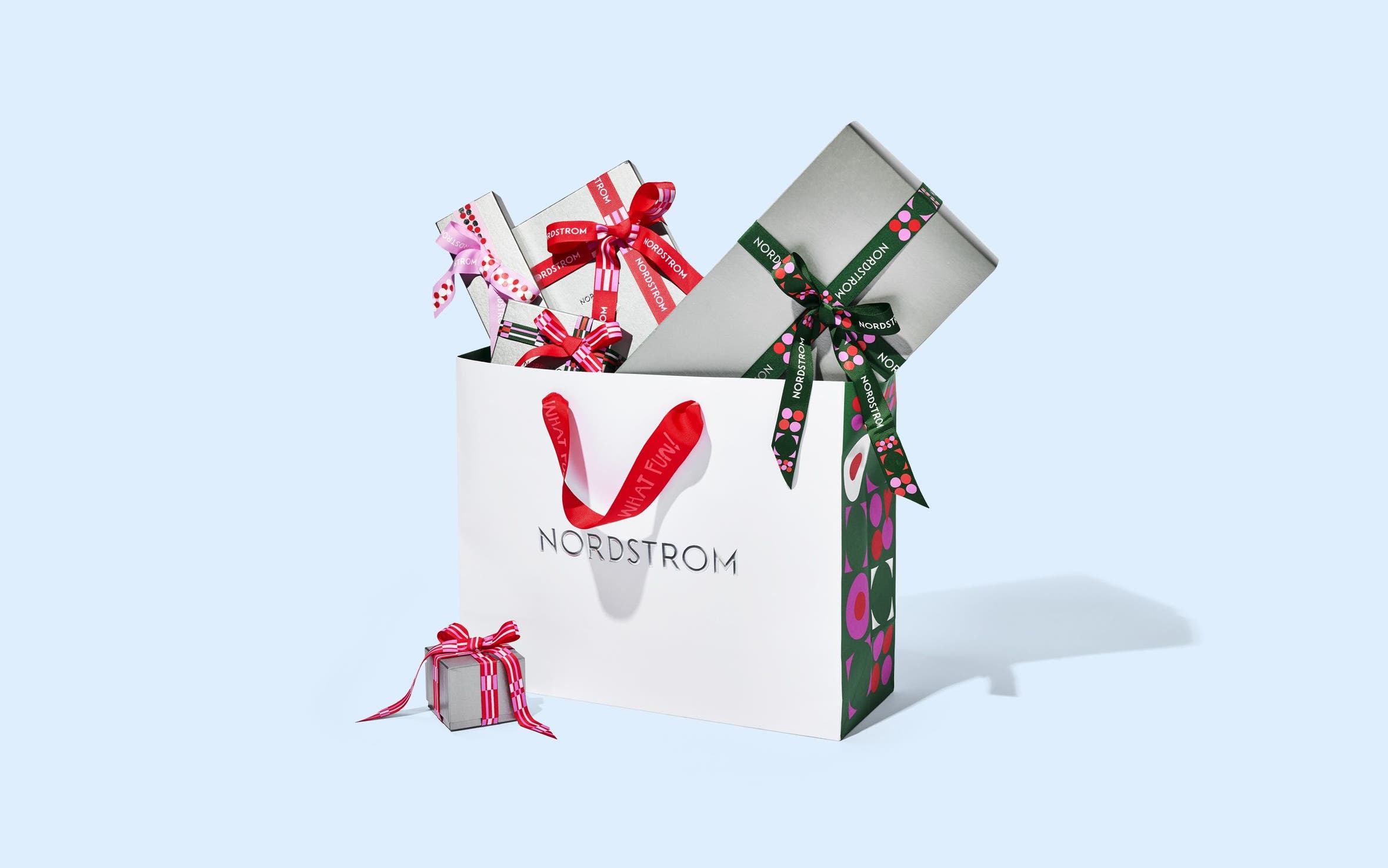 Nordstrom gift boxes and ribbon with a Nordstrom bag.