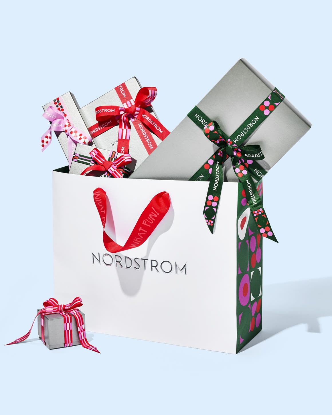 Nordstrom gift boxes and ribbon with a Nordstrom bag.