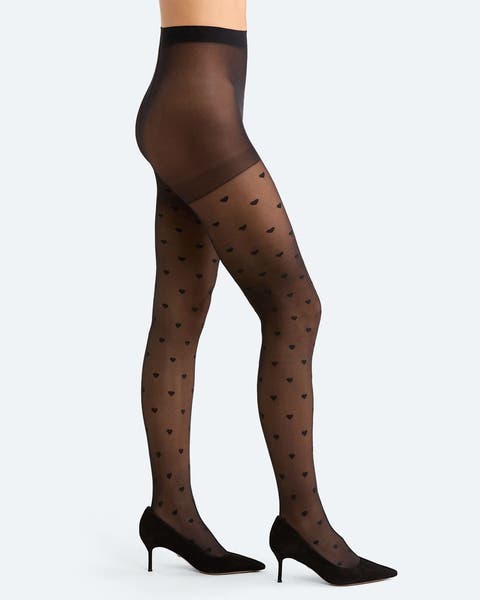 A woman wearing a pair of polka dot tights.