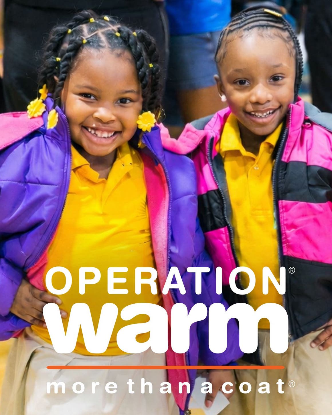 Help support Operation Warm. Two little girls smiling and wearing colorful coats.