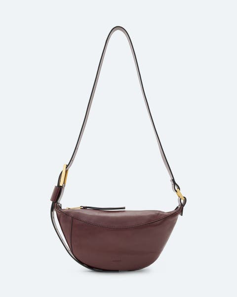 A brown crossbody bag with gold hardware.