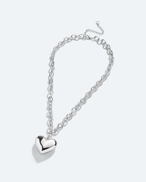 A silver chain necklace with a heart pendant.