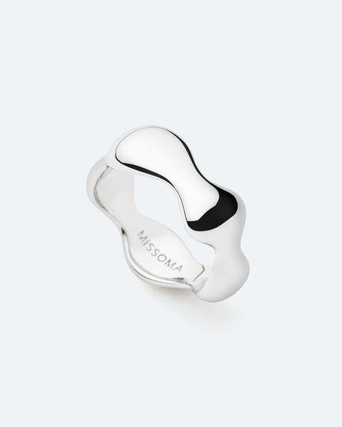 A silver ring with a wavy, organic design.