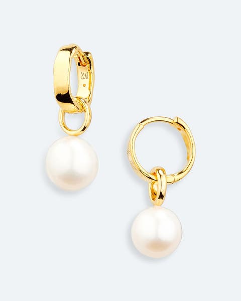 Gold hoop earrings with pearl drops.