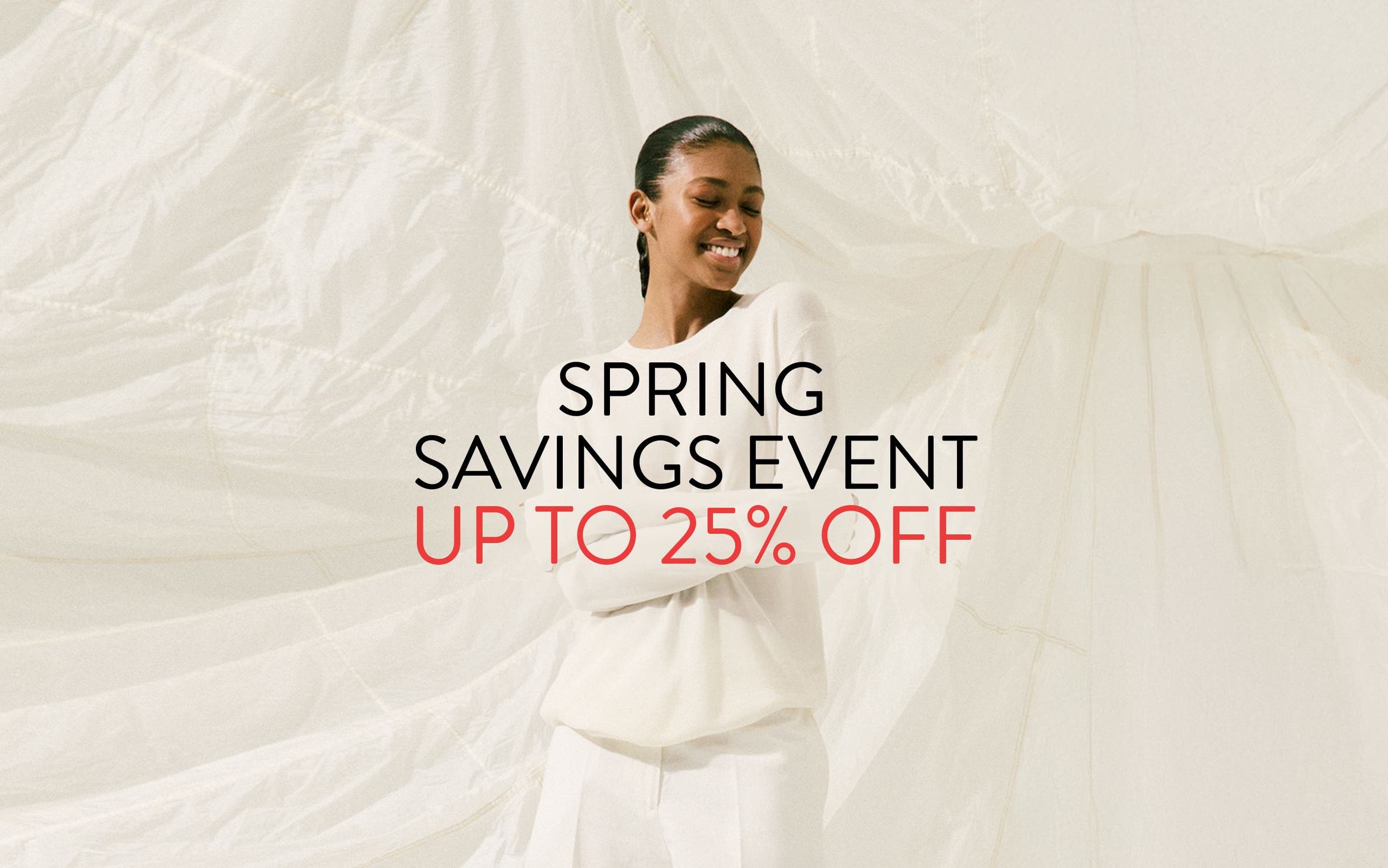 Spring Savings Event up to 25% off; woman wearing a white sweater and pants.