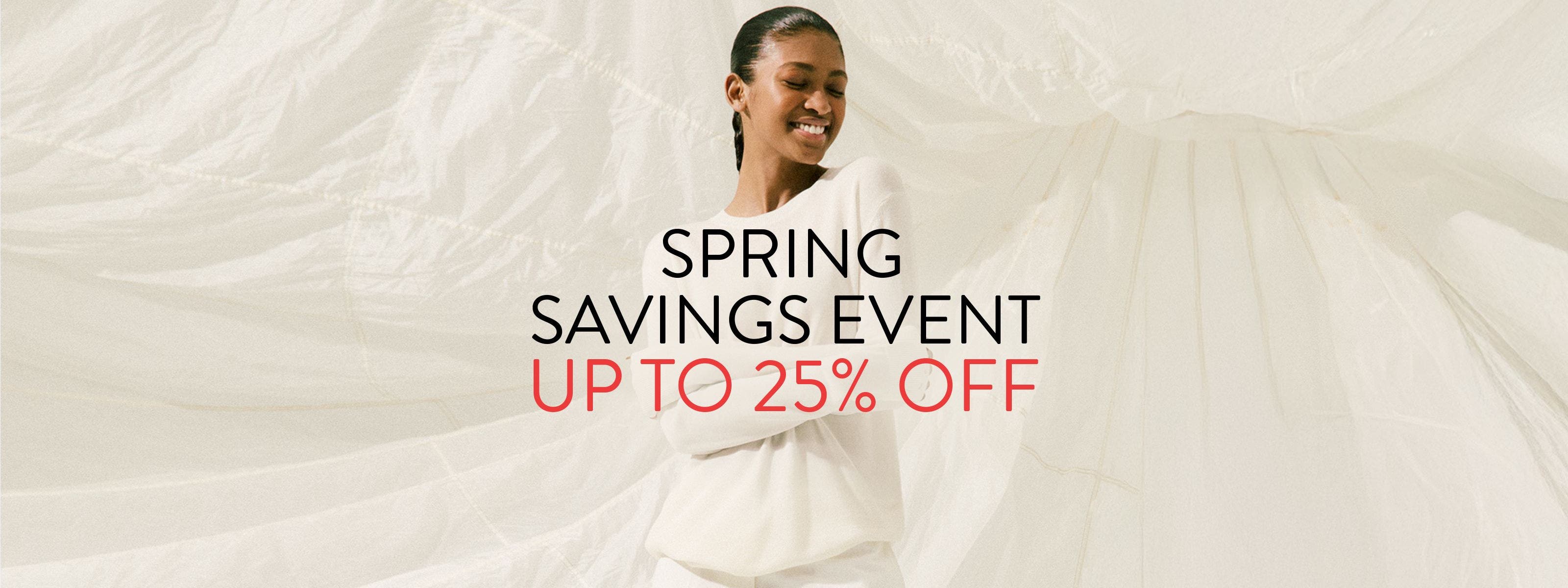 Spring Savings Event up to 25% off; woman wearing a white sweater and pants.