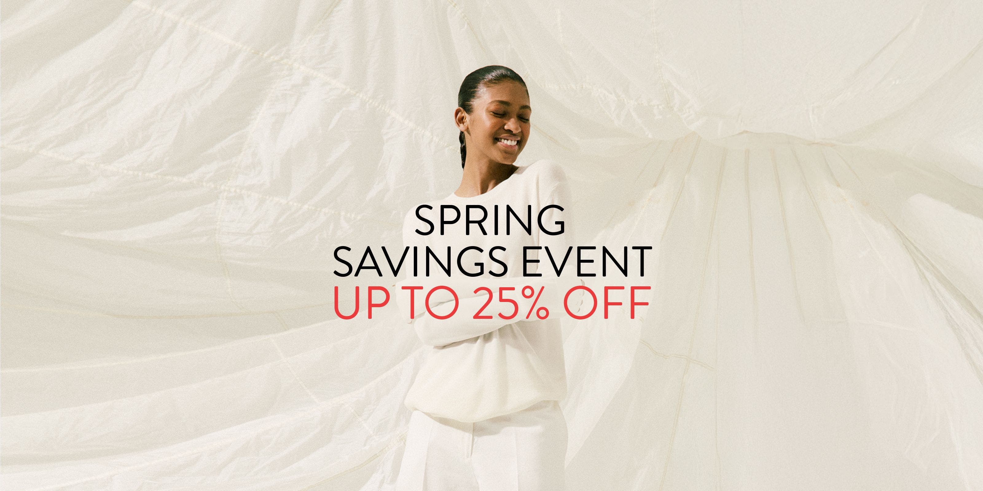 Spring Savings Event up to 25% off; woman wearing a white sweater and pants.