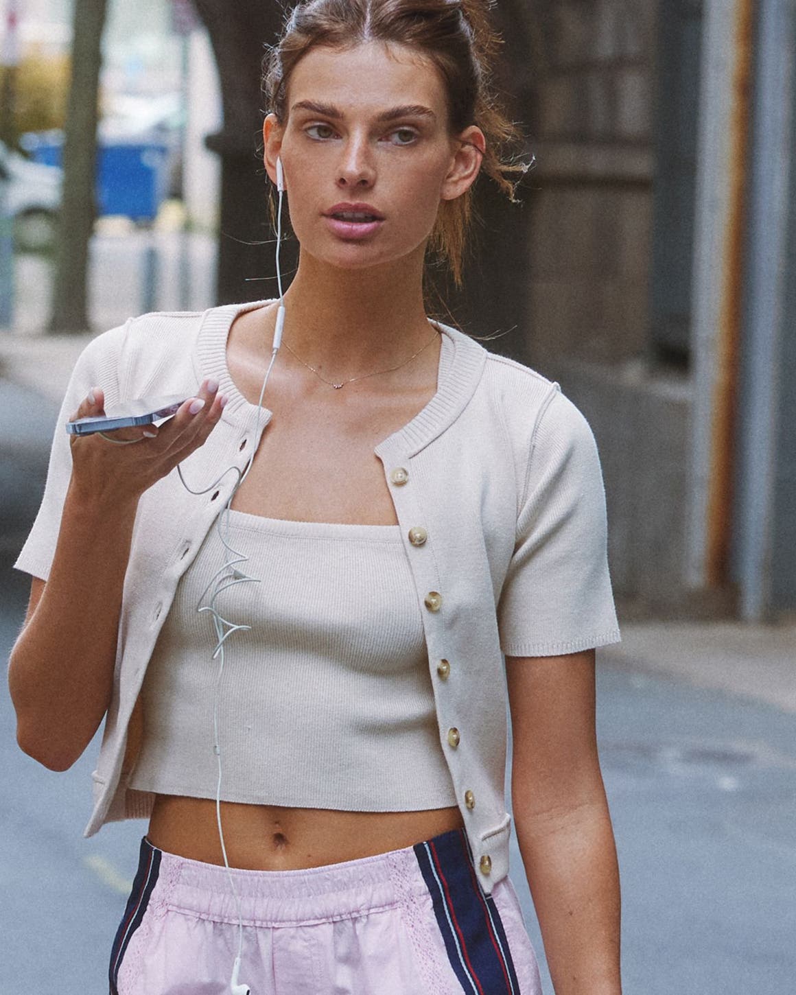 Woman wearing cropped tank and matching short-sleeve cardigan from Free People.