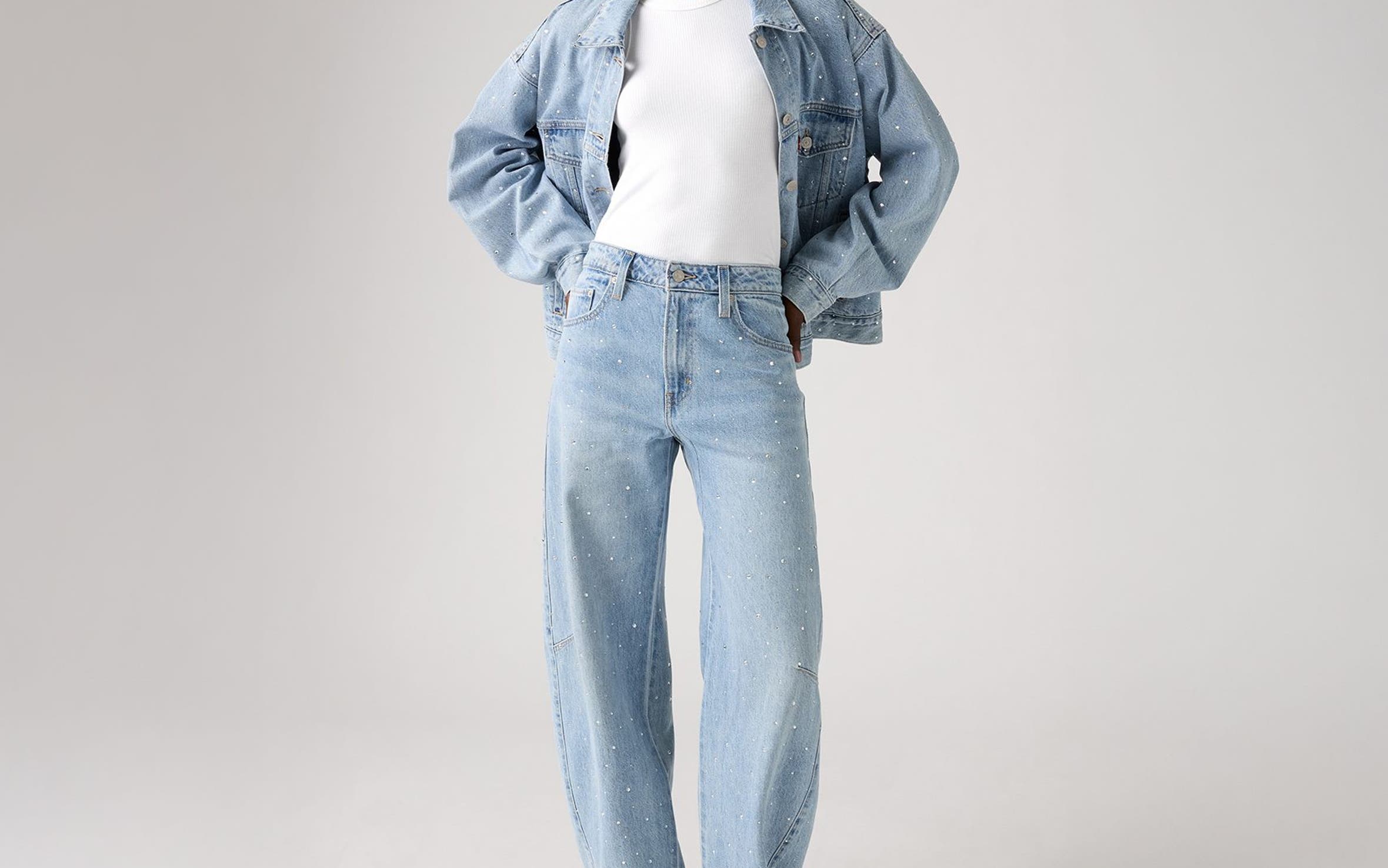 Alt text: A woman wearing an embellished denim jacket and matching jeans.