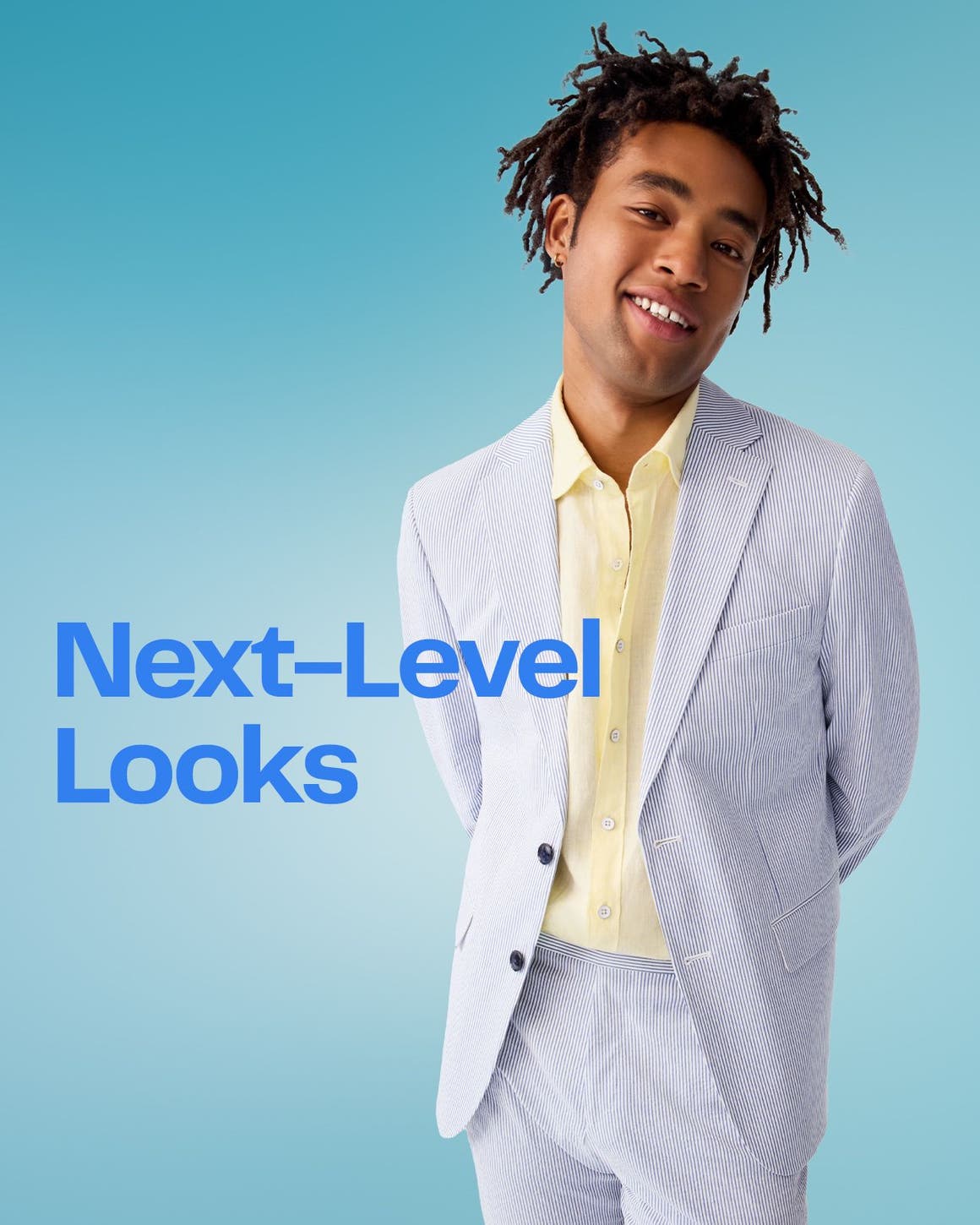 A man wearing a light-blue suit and yellow button-up shirt.