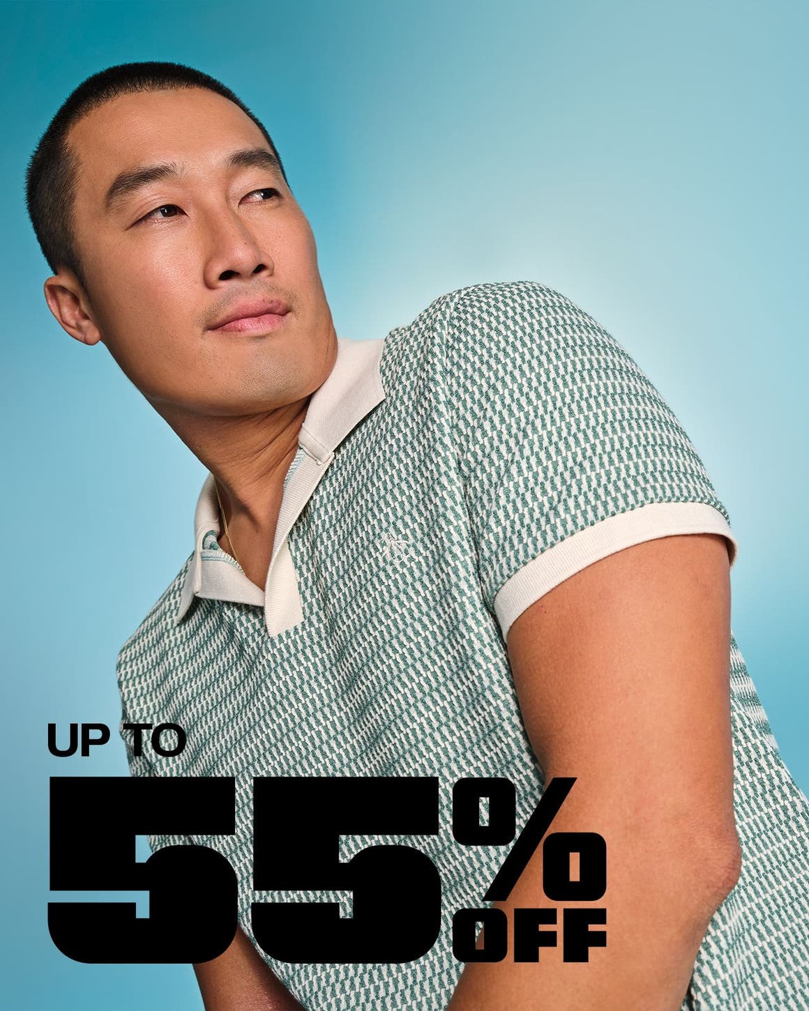 A man wearing a patterned, knit polo.