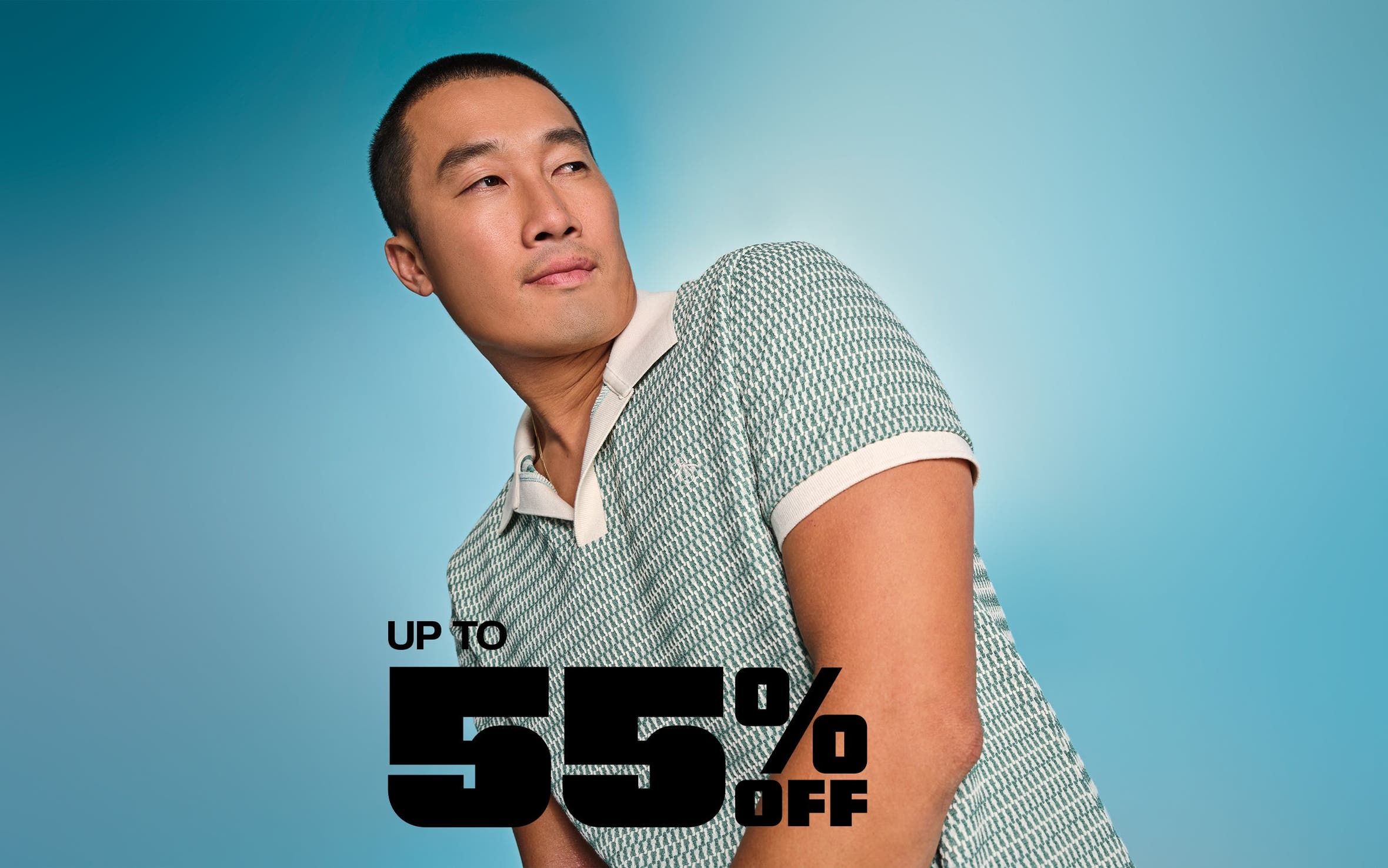 A man wearing a patterned, knit polo.