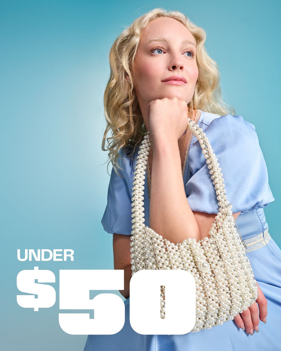 A woman holding a pearly beaded handbag.