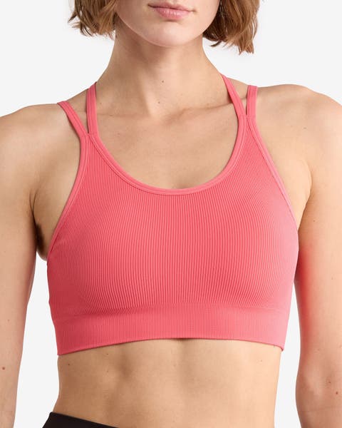 A woman wear a pink sports bra by Z by Zella.