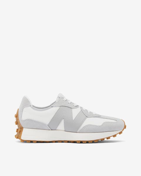 A women's New Balance sneaker in gray and white.