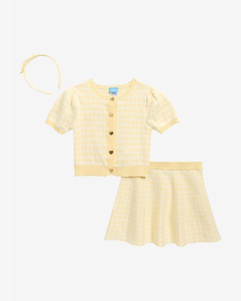 A girls' yellow gingham knit set with short‑sleeve cardigan, A‑line skirt, and matching headband.