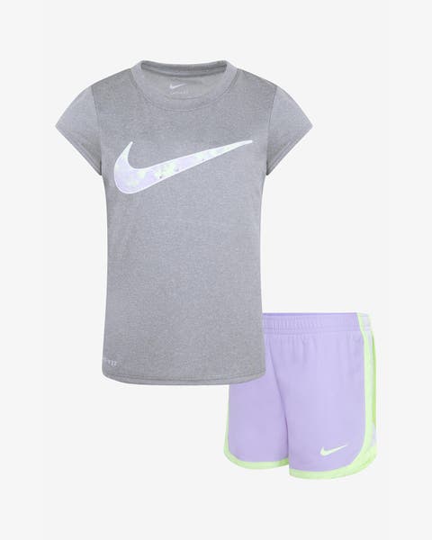A girls' Nike gray logo T-shirt and lavender shorts.