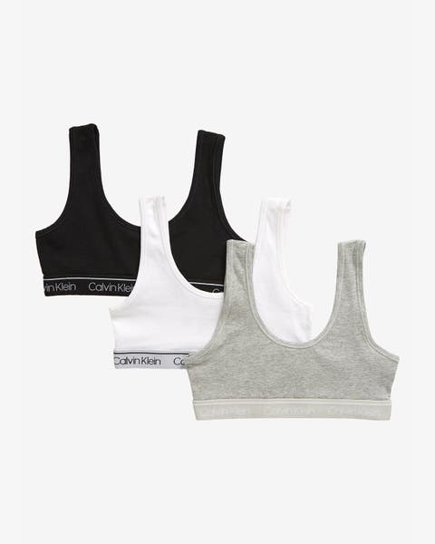 3‑pack girls’ bralettes in black, white, and heather gray with racerback and logo elastic band.