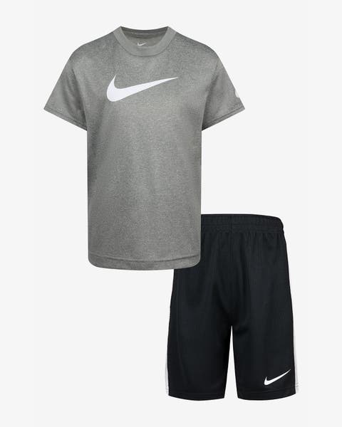 A boys' Nike gray logo T-shirt and black shorts.
