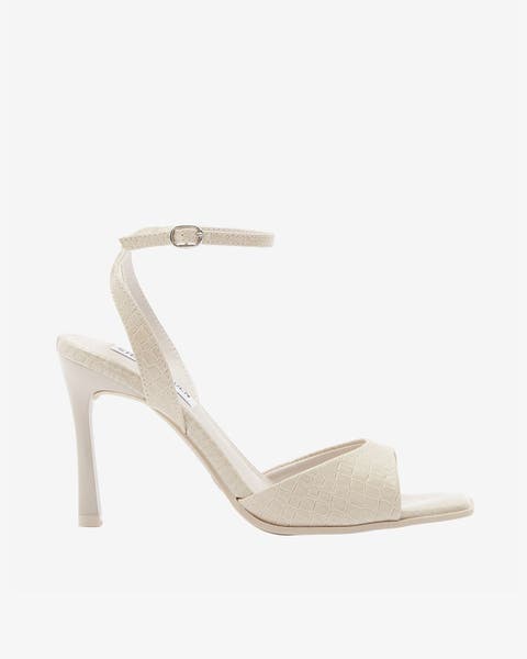 Beige stiletto heel sandal with ankle strap.