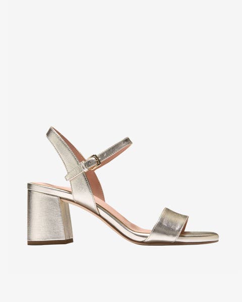 Gold metallic ankle‑strap block‑heel sandal.