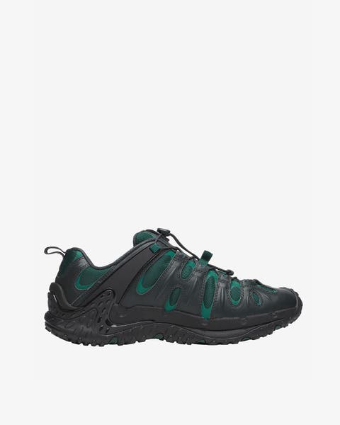 A men's black and green trail running shoe.