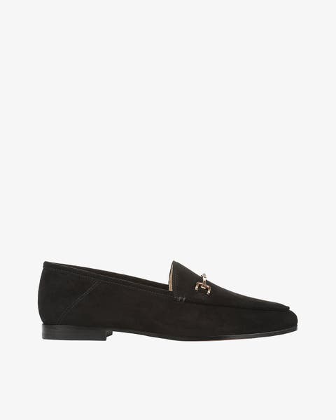 A black suede loafer with gold horsebit hardware.