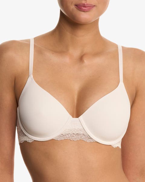 A woman wearing a light-colored bra.