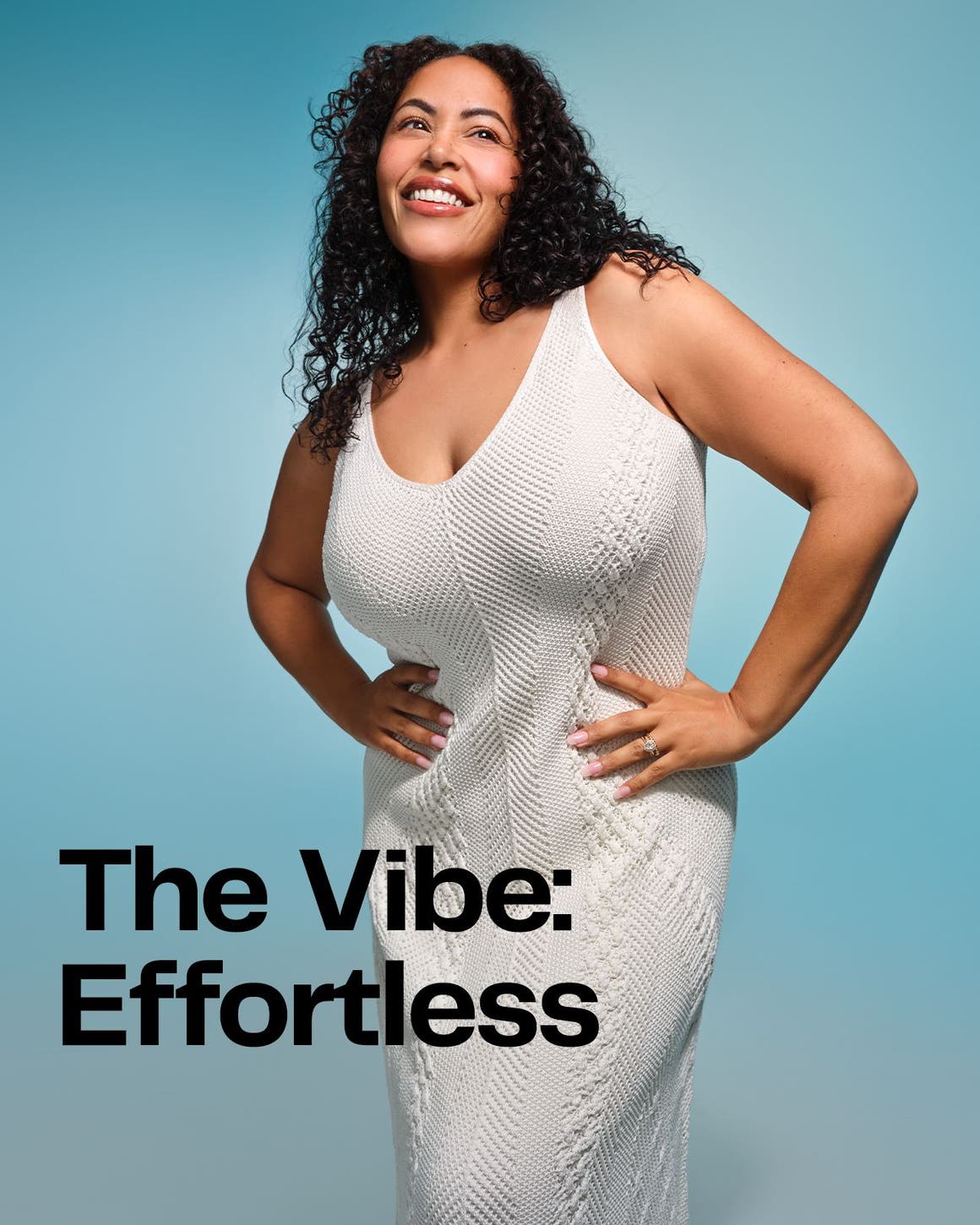 A woman wearing a white textured cable-knit sleeveless midi summer dress with a scoop neckline against a light blue background.