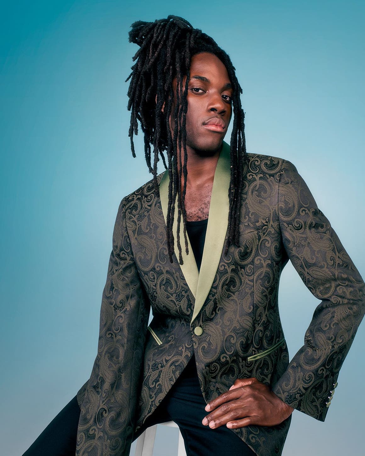 A man wearing a suit jacket with black pants. 