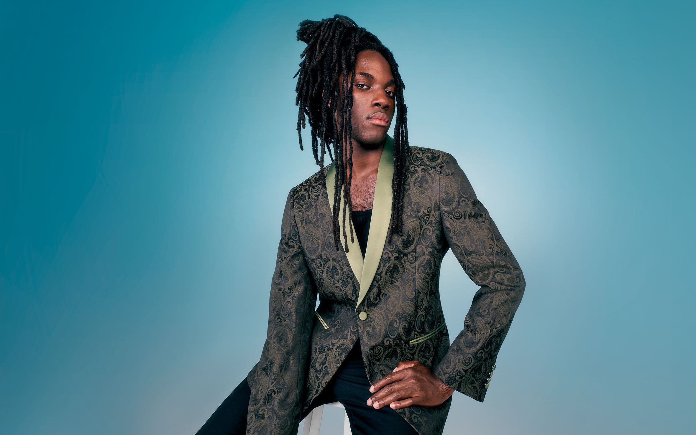 A man wearing a suit jacket with black pants. 
