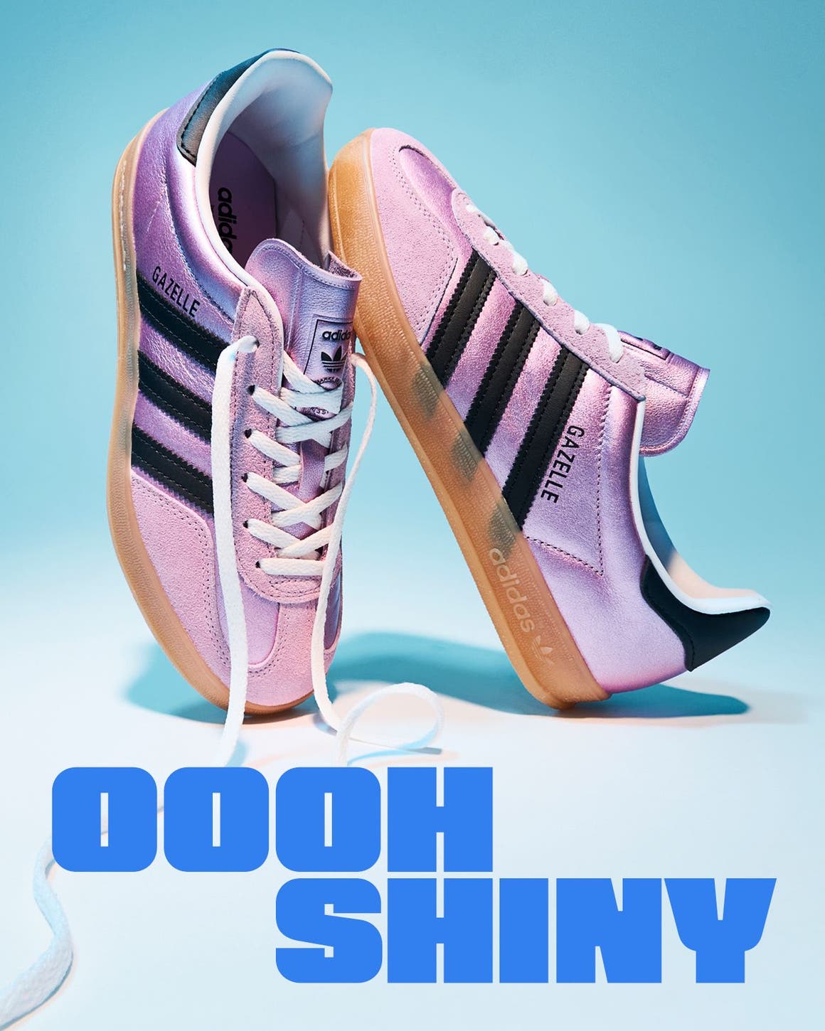 A pair of shiny pink adidas sneakers.