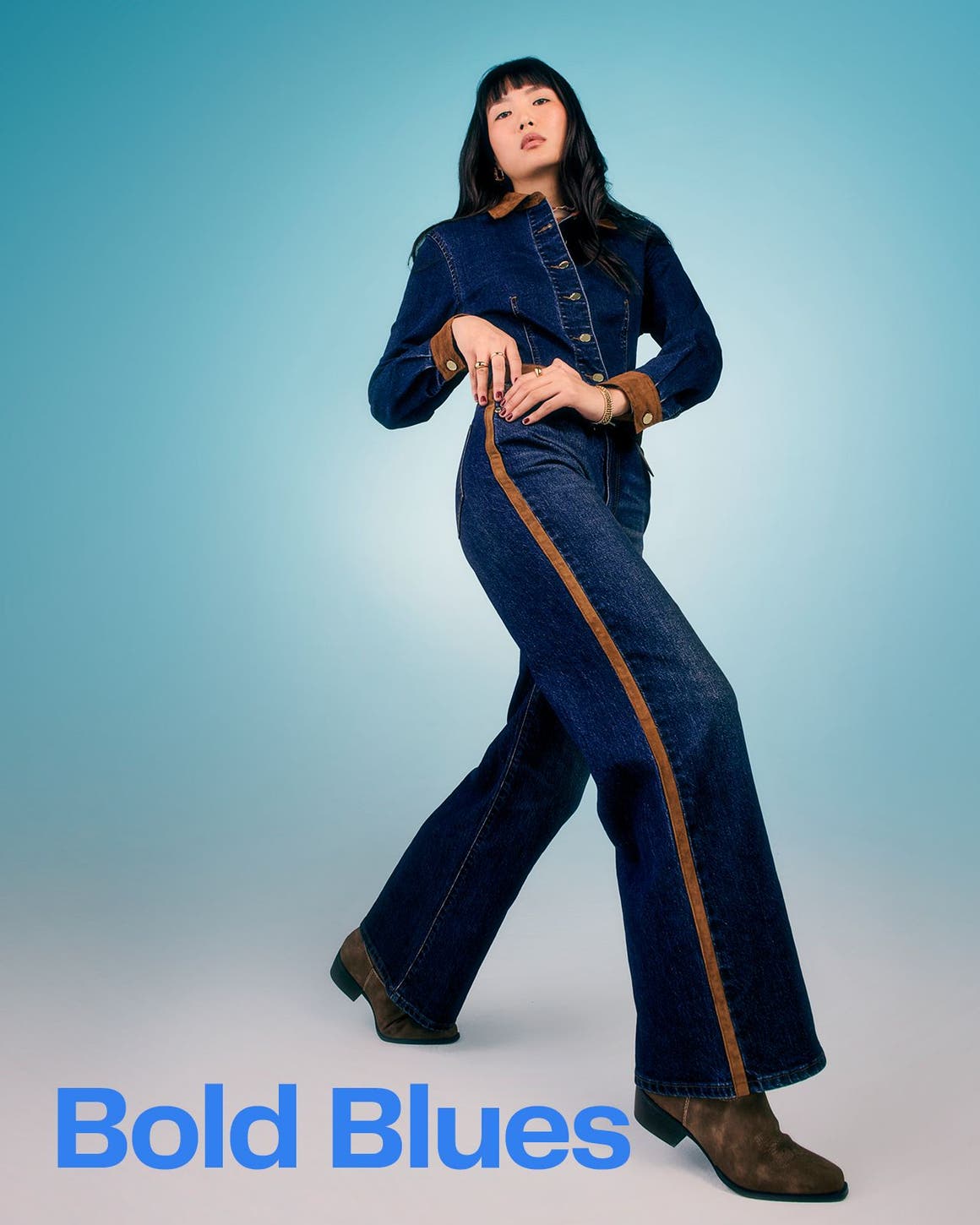 A woman wearing a denim jumpsuit.