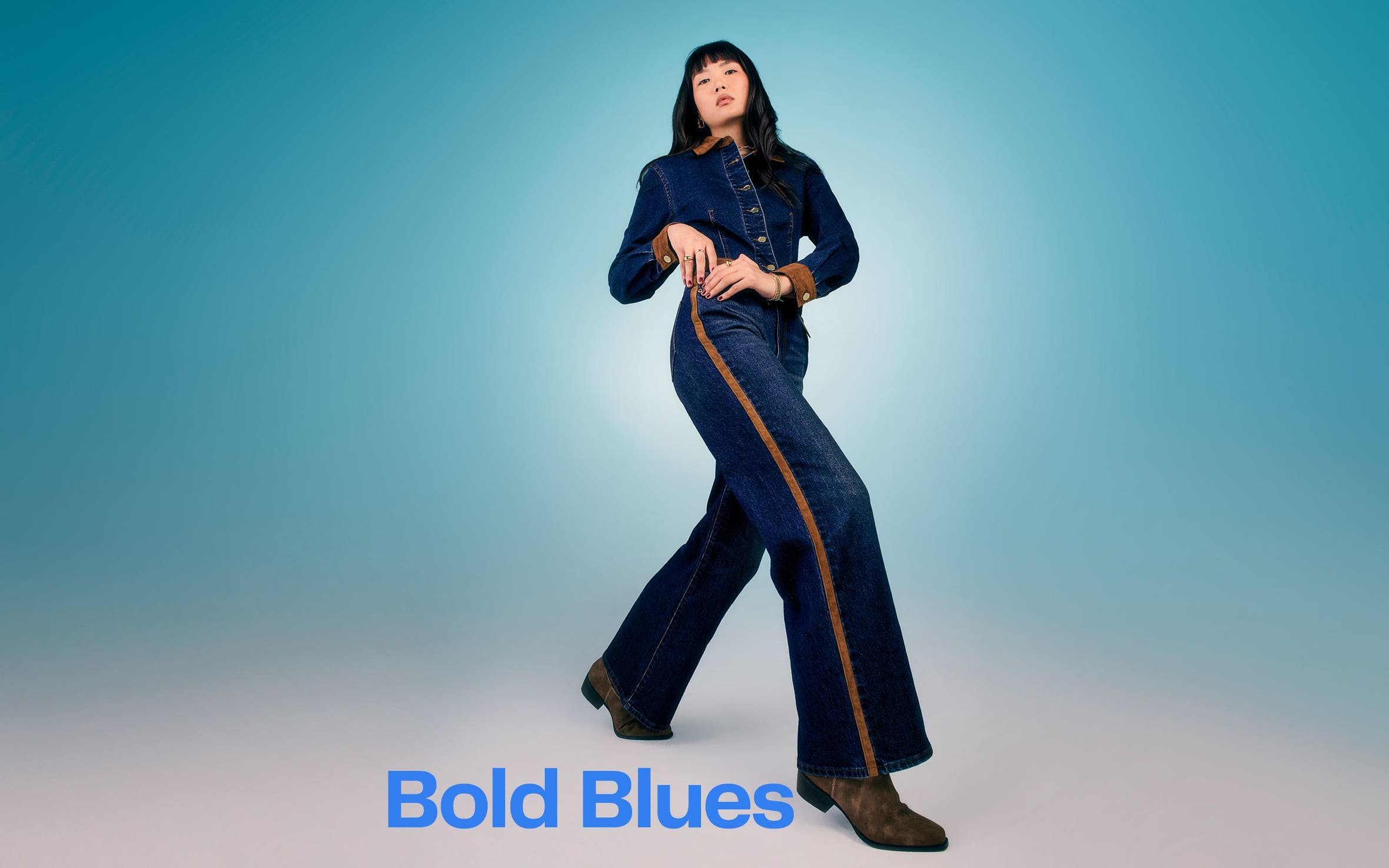 A woman wearing a denim jumpsuit.