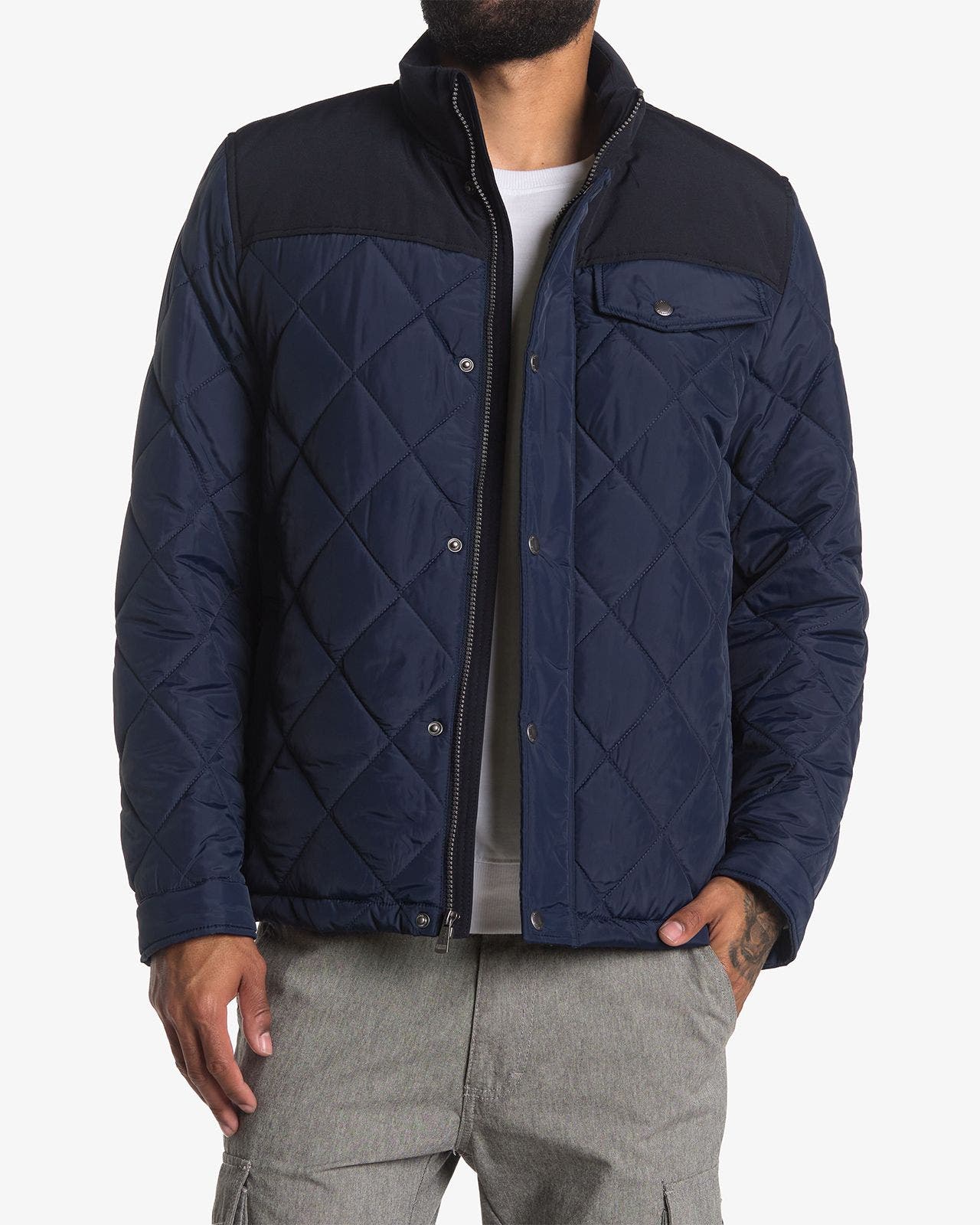 Men's navy blue quilted jacket with contrast yoke and chest pocket.