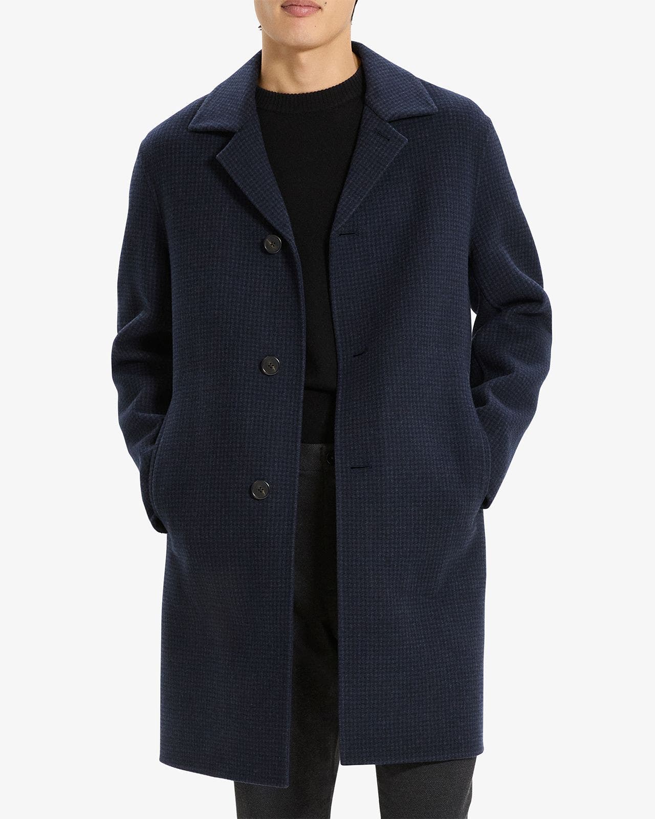 Men's navy blue wool topcoat with notched lapel and three-button closure.