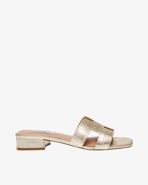 Gold sandal with low heel.