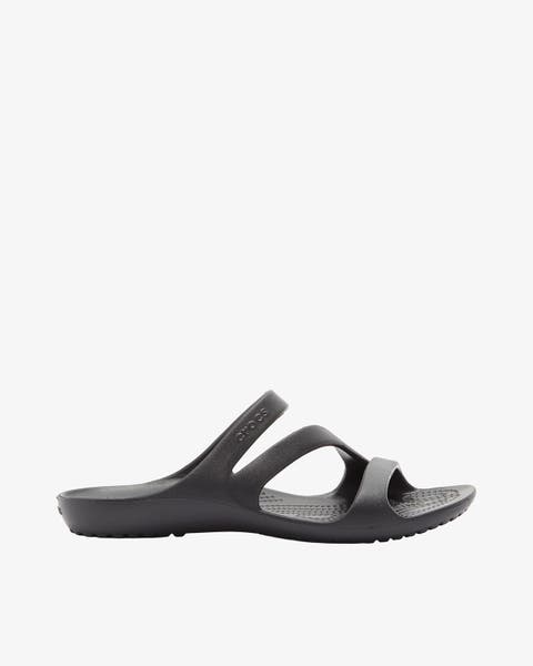 A black sporty slide sandal with two asymmetrical straps and a contoured, textured footbed.