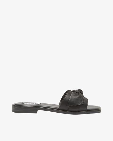Black slide sandal with a single wide, padded strap featuring a knotted detail.
