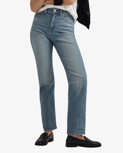 Woman in light wash straight leg jeans.