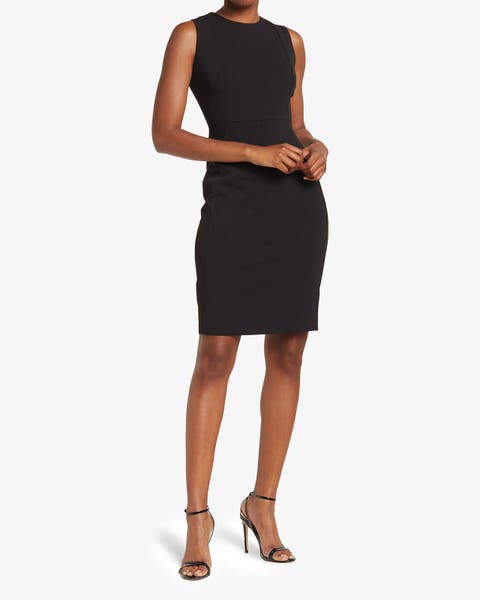Model wearing a black sleeveless sheath dress with nude strappy heels.