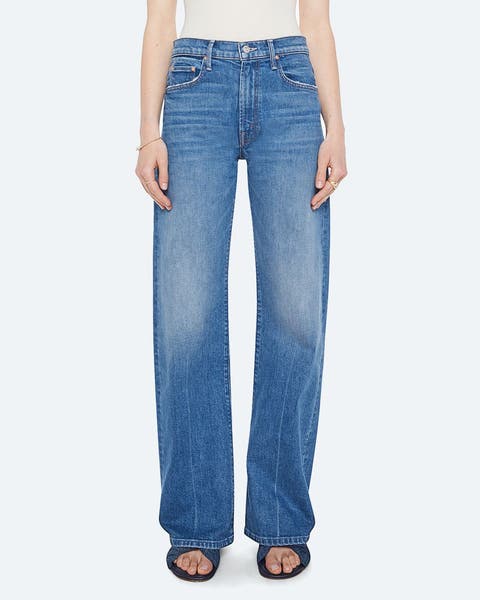 A woman wearing high-waisted jeans.