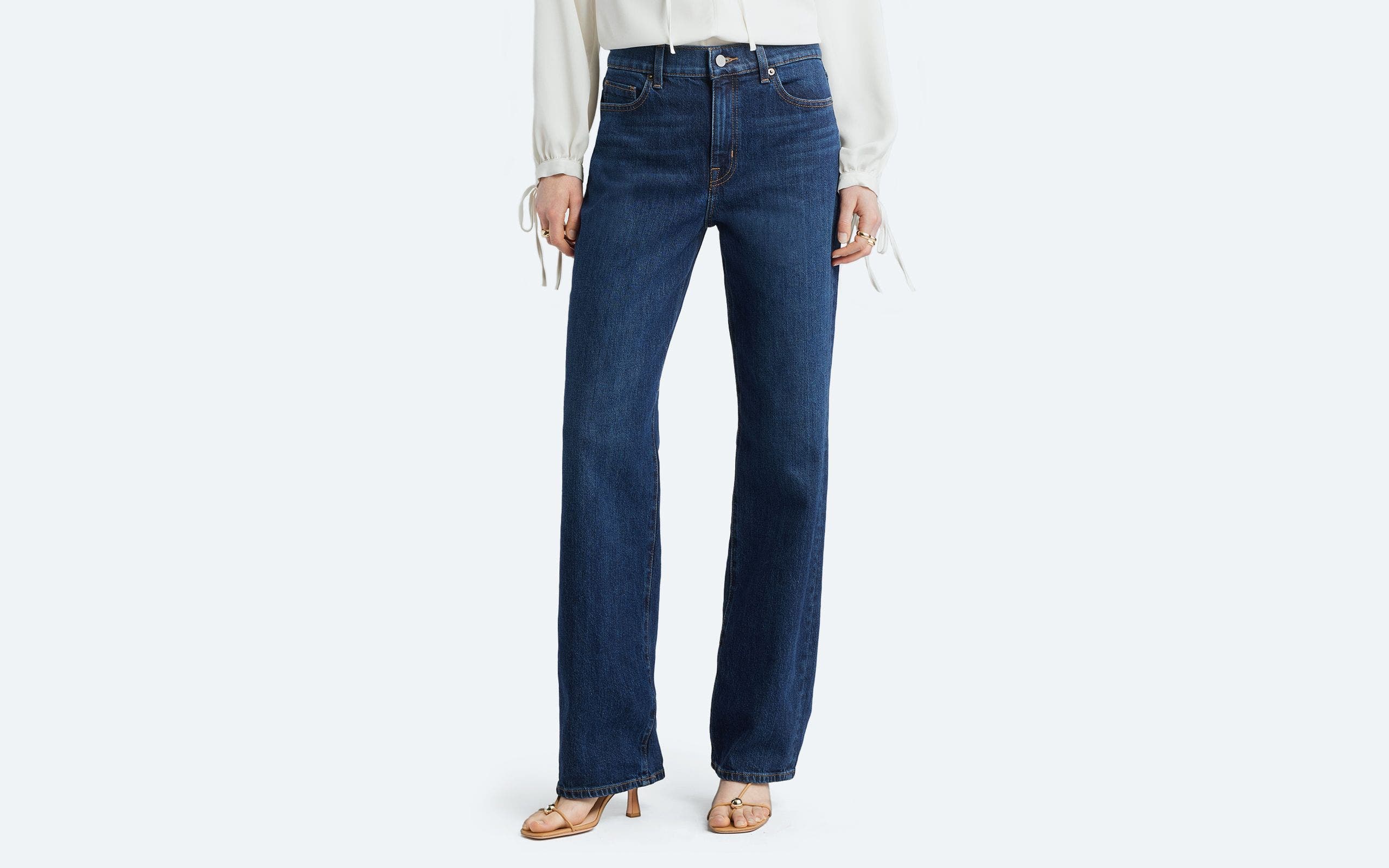 A woman wearing straight-leg jeans.