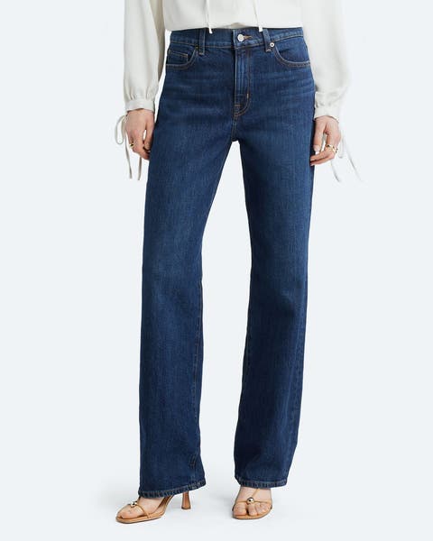 A woman wearing straight-leg jeans.