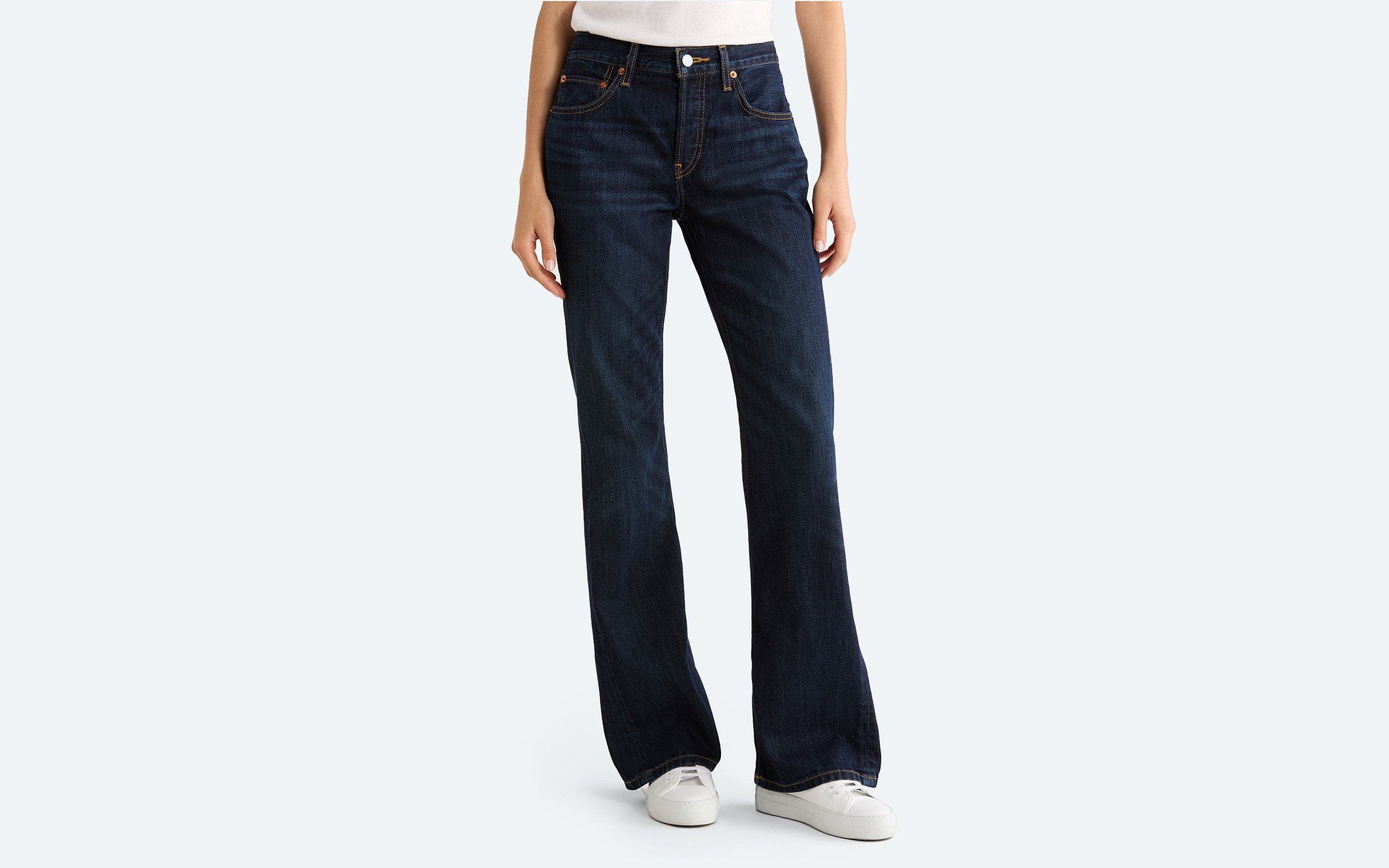 A woman wearing bootcut jeans.