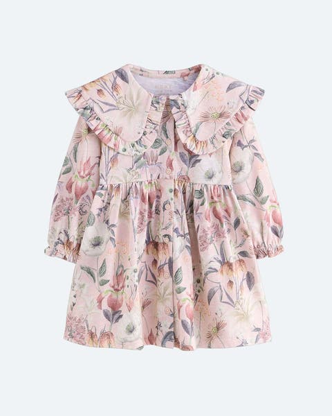 A pink floral dress with a wide, ruffled collar.