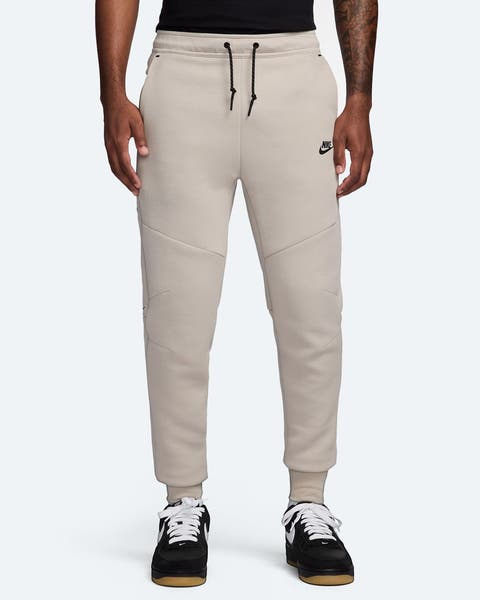 A man wearing cream-colored sweatpants.