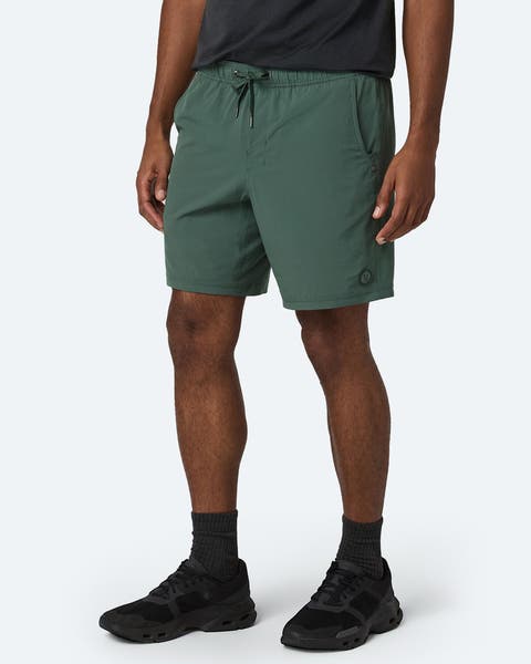 A man wearing green athletic shorts.