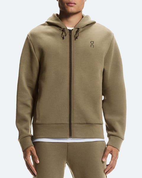 A man wearing a zip-front hoodie.