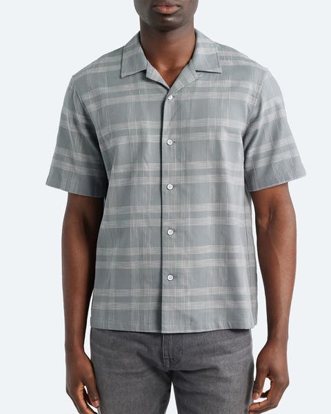 A man wearing a horizontally striped button-up shirt.